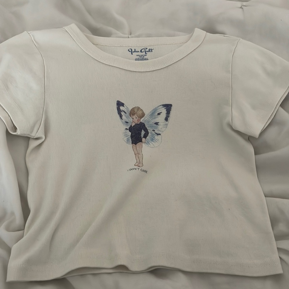 crop top with angel baby on front with the words “I don’t care” size 2
